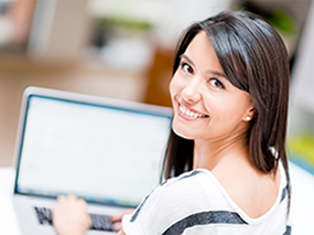Woman smiling with laptop computer